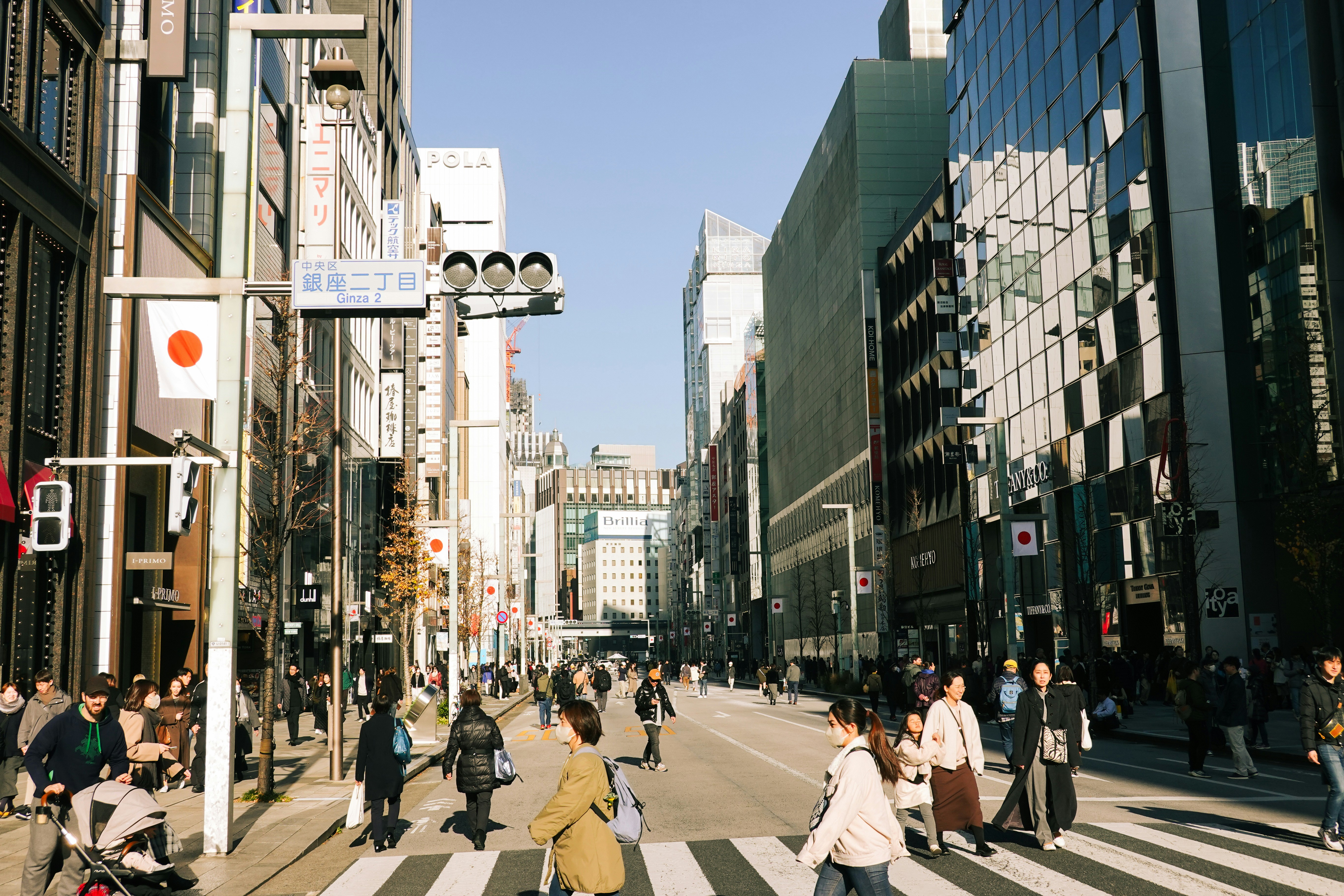 a group of people walking across a cross walk