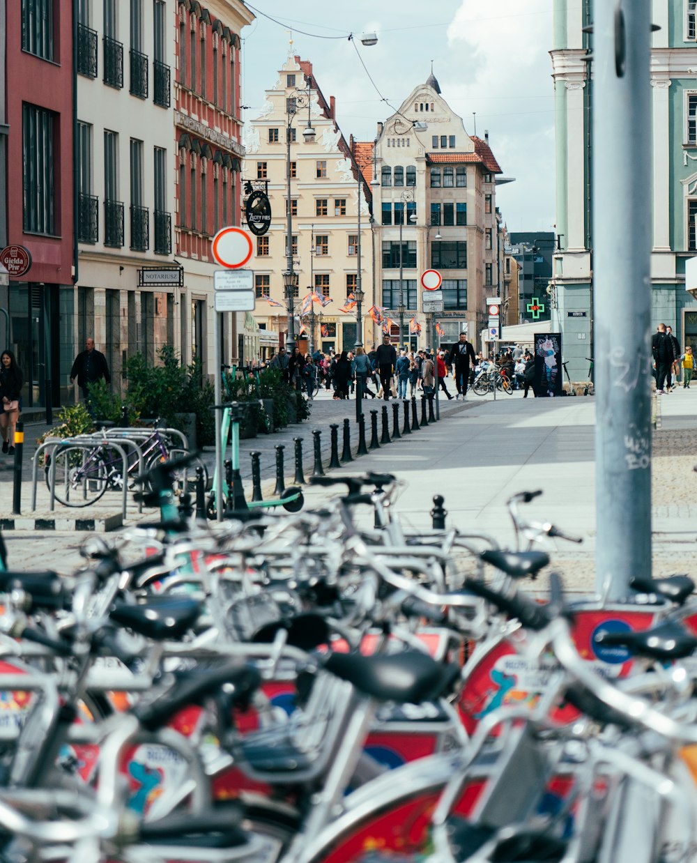 a bunch of bikes parked on the side of the road