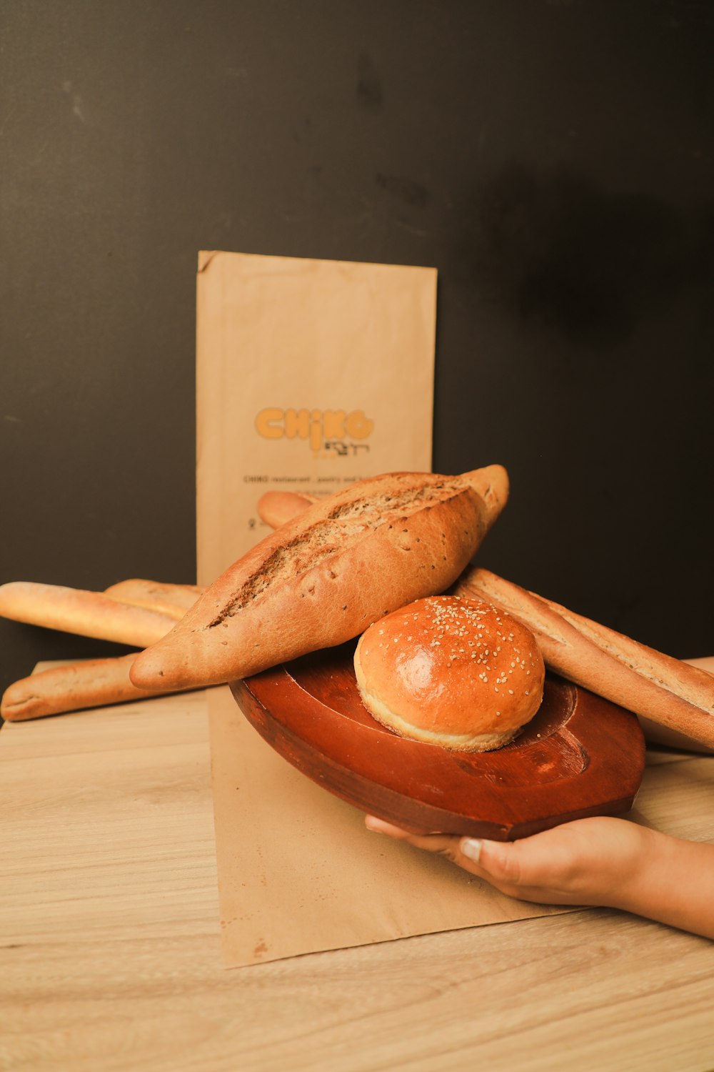 a person is holding a plate with bread on it