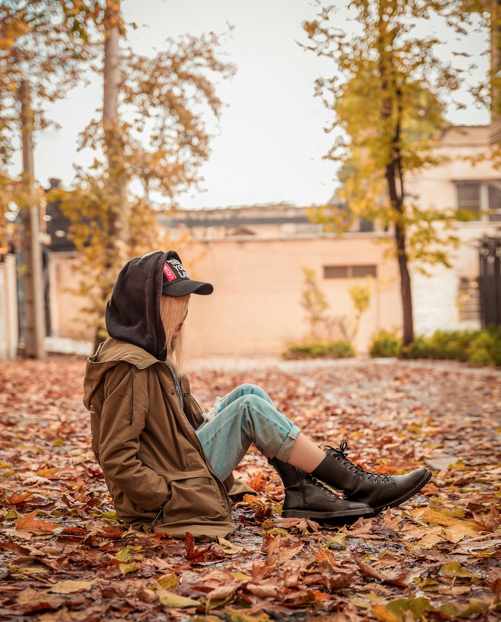 a person sitting on the ground with a hat on