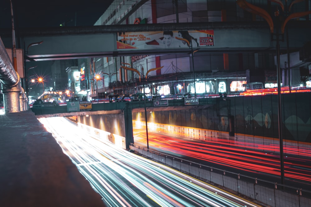 a city street filled with lots of traffic at night