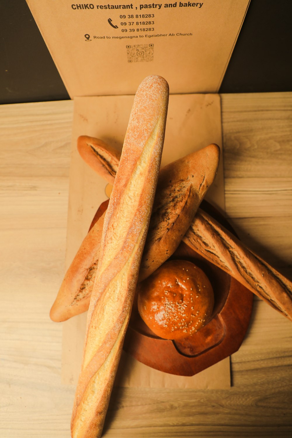 a couple of loaves of bread sitting on top of a wooden table