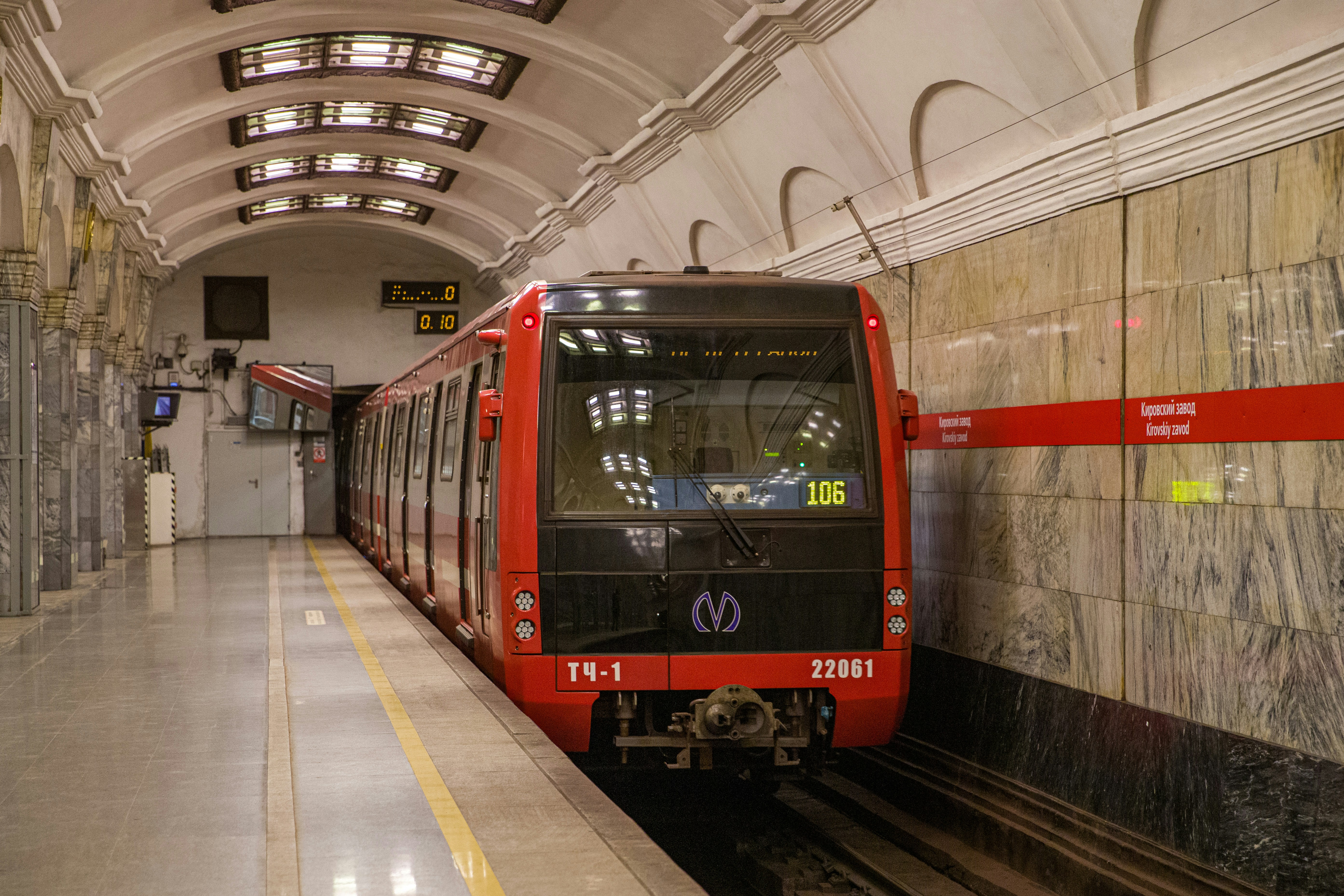 a red train pulling into a train station