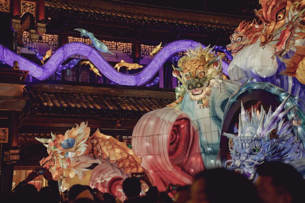 a group of people standing in front of a dragon statue