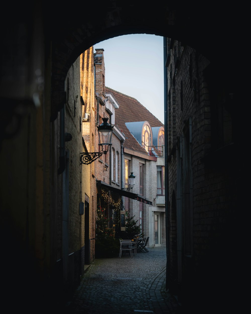 a view of a street through an arch in a building