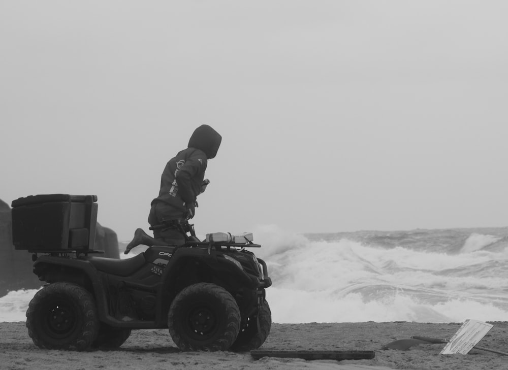 a man riding on the back of a four wheeler