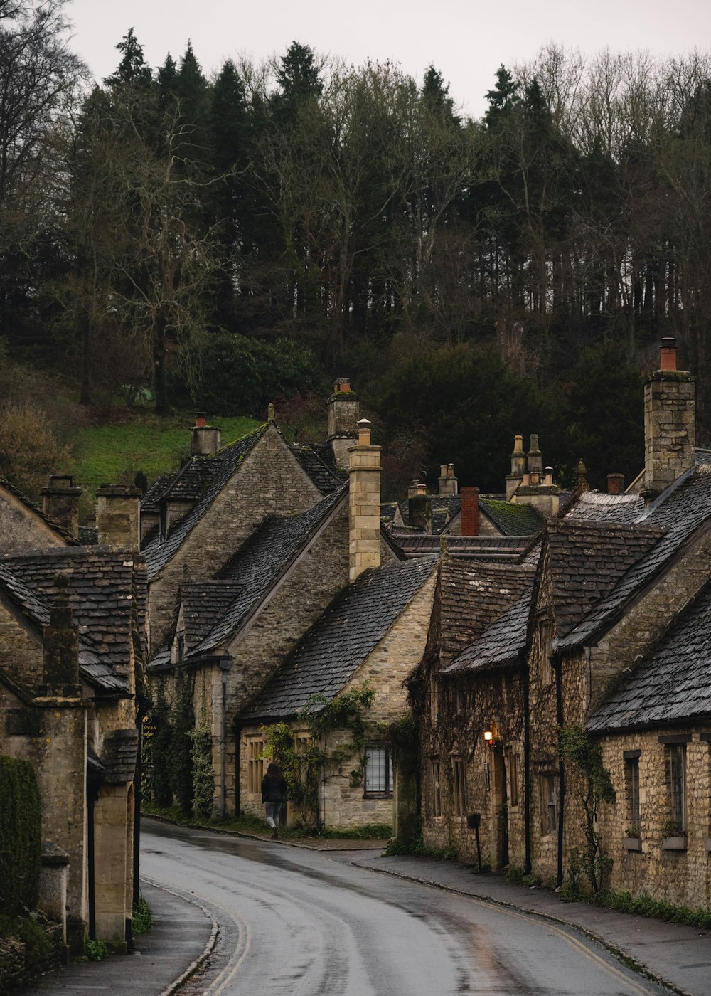 uma rua ladeada por casas de pedra em uma área rural