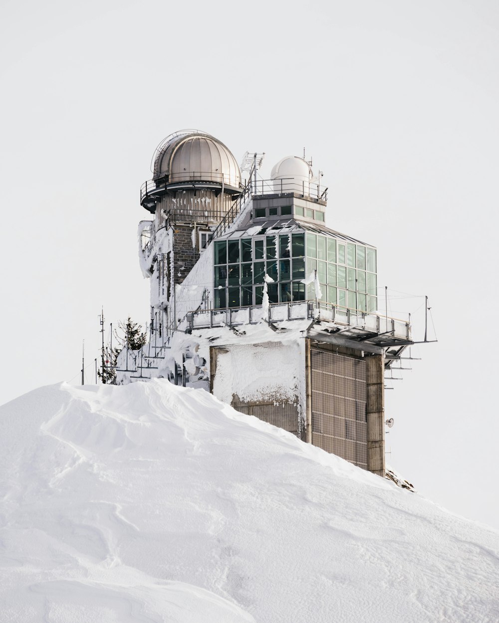 a snow covered hill with a building on top of it