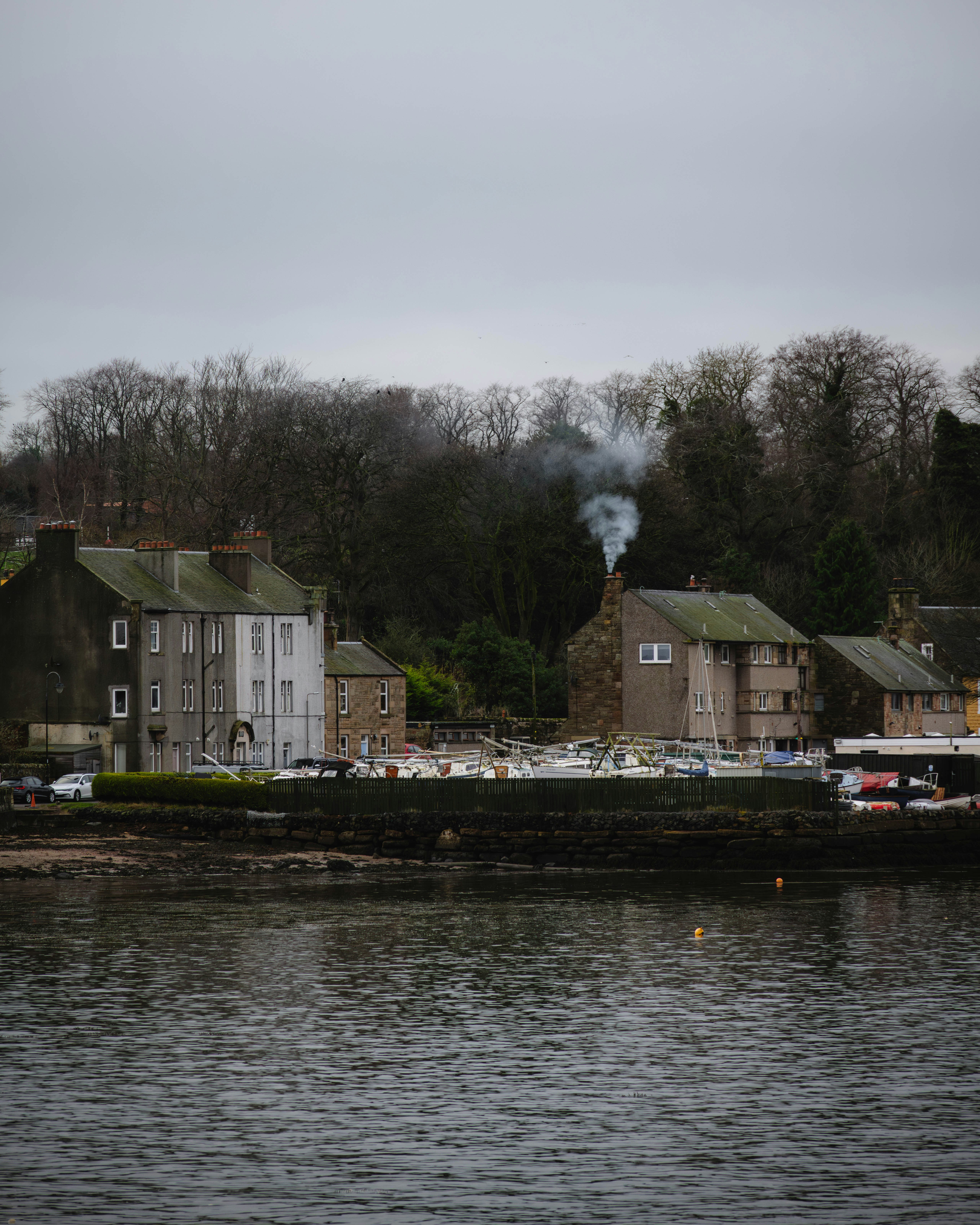 a body of water with houses on the shore