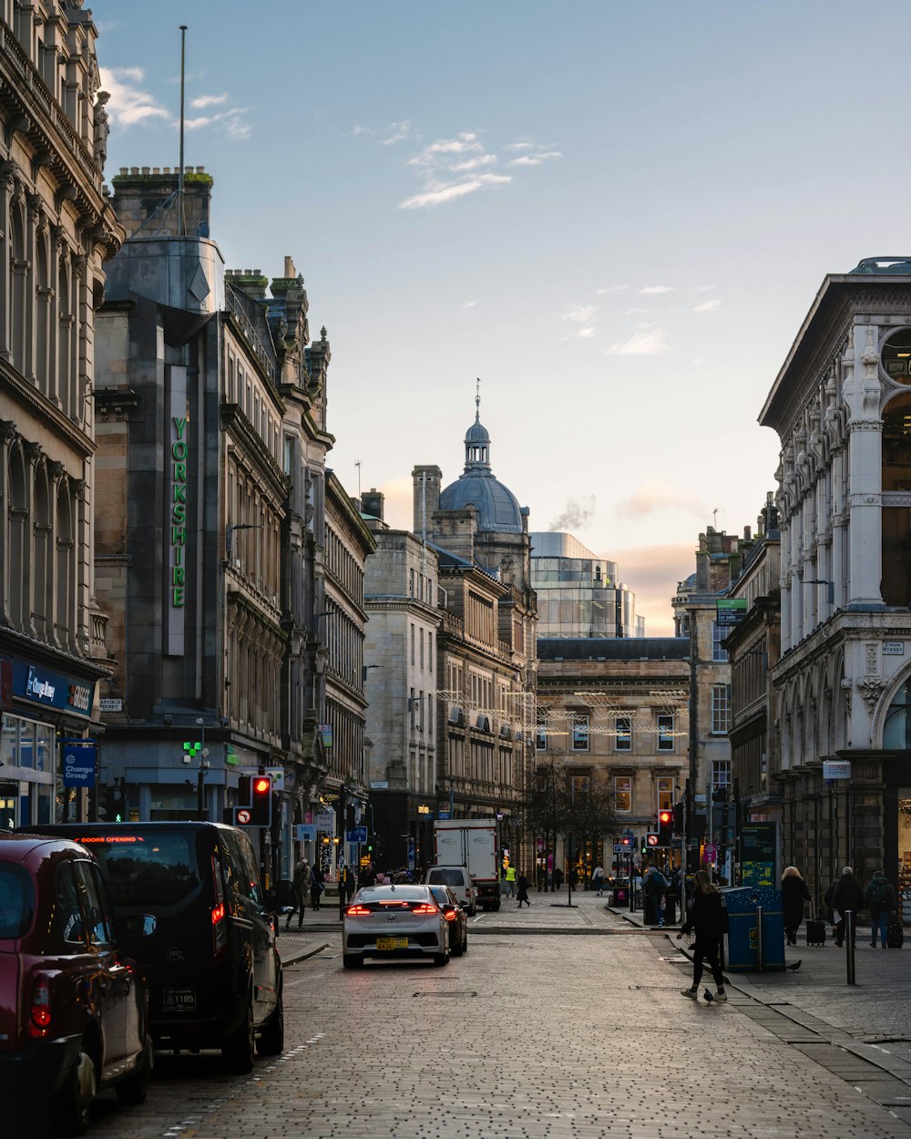 a city street filled with lots of traffic and tall buildings