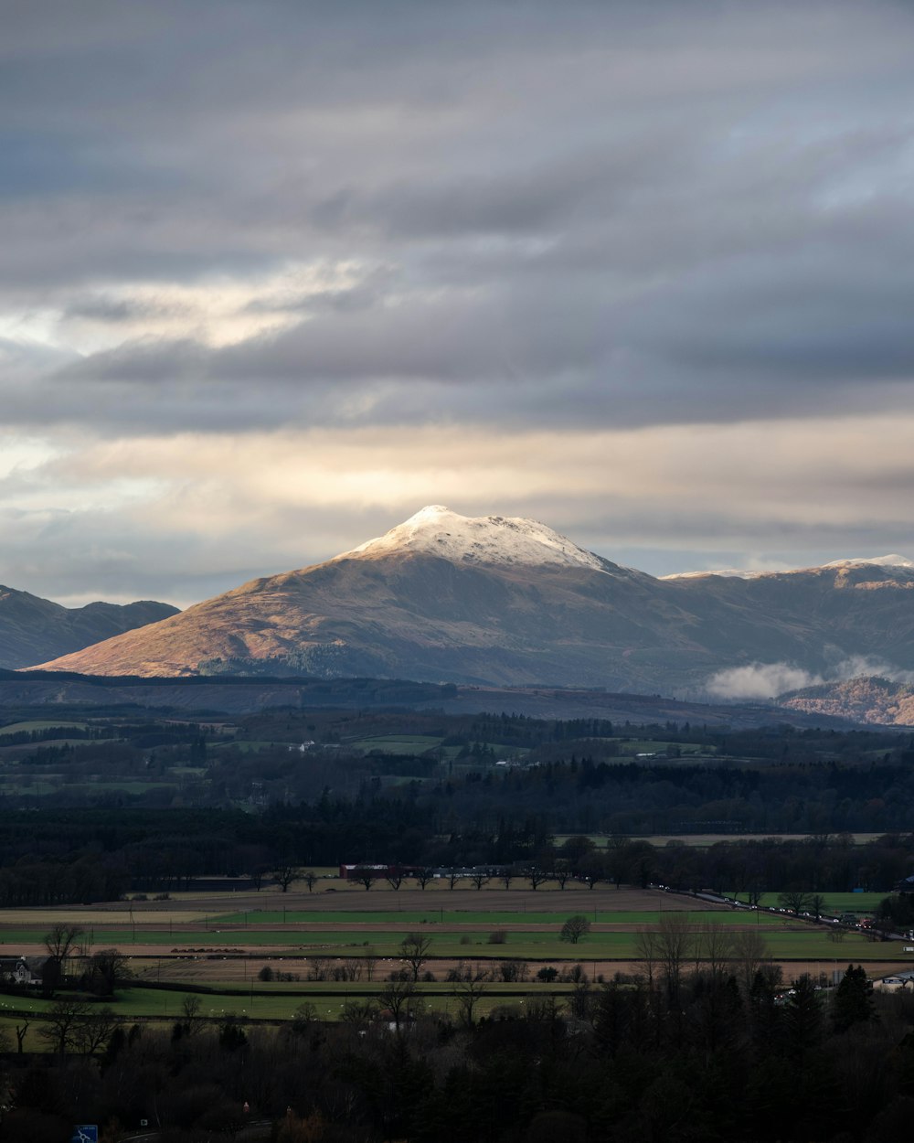 a view of a mountain range with clouds in the sky