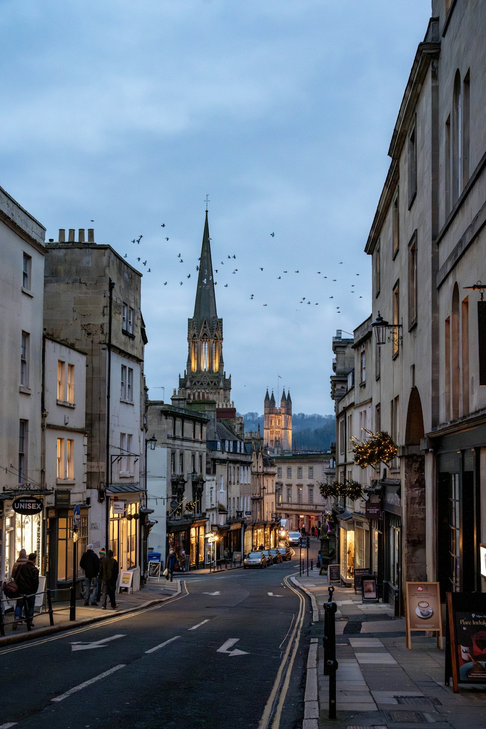 a city street with a clock tower in the background