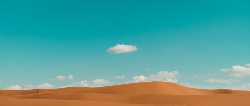 a cloud in the sky over a desert landscape