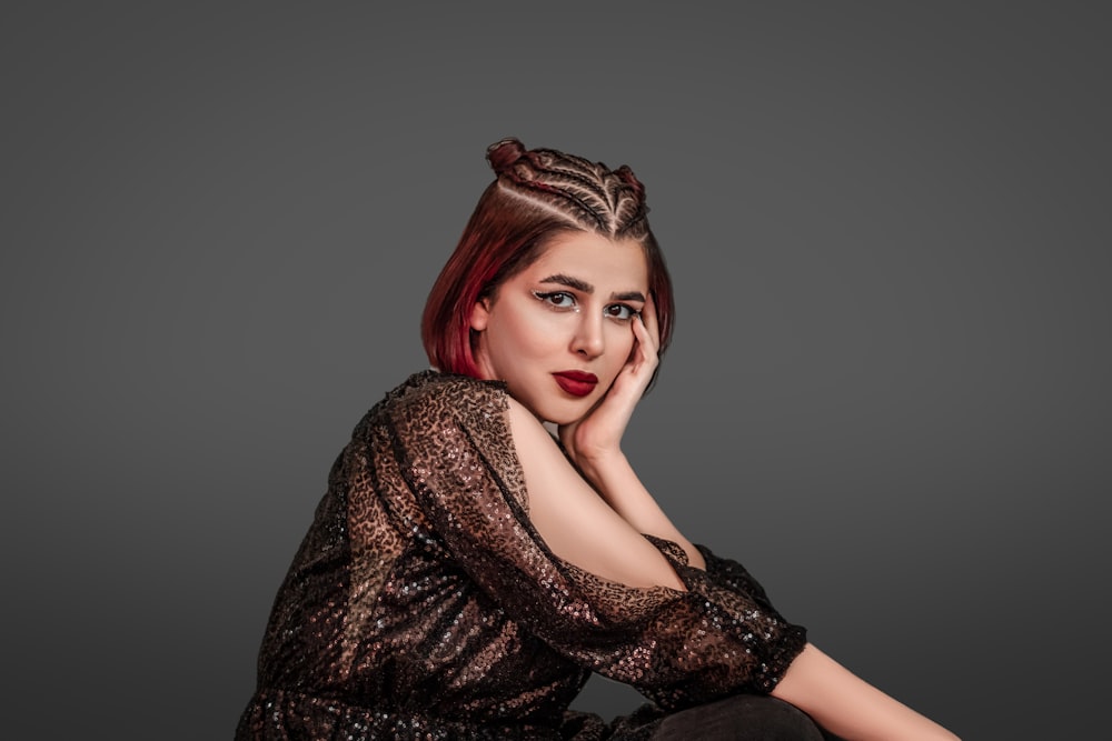 a woman with red hair sitting on the floor