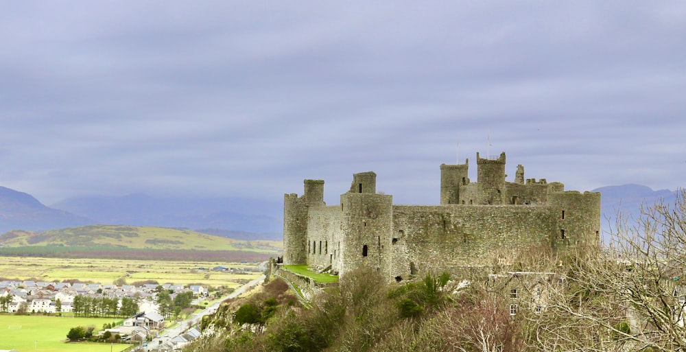 a castle on a hill overlooking a town