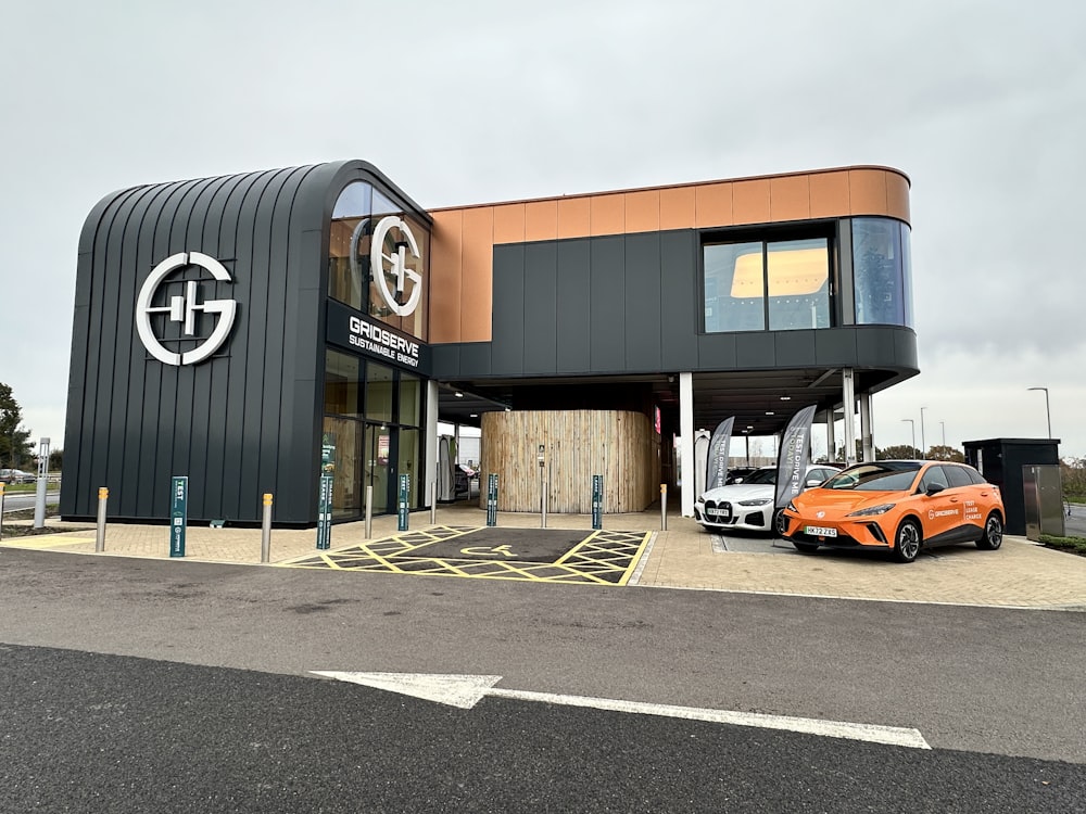 an orange car is parked in front of a building