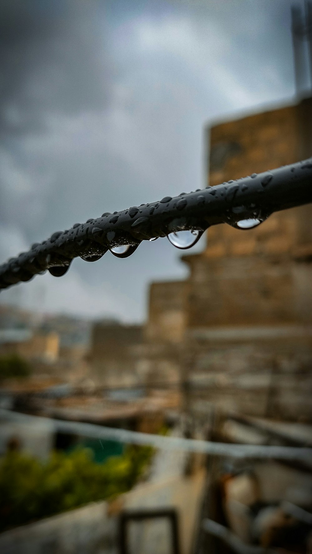 a close up of a water drop on a wire