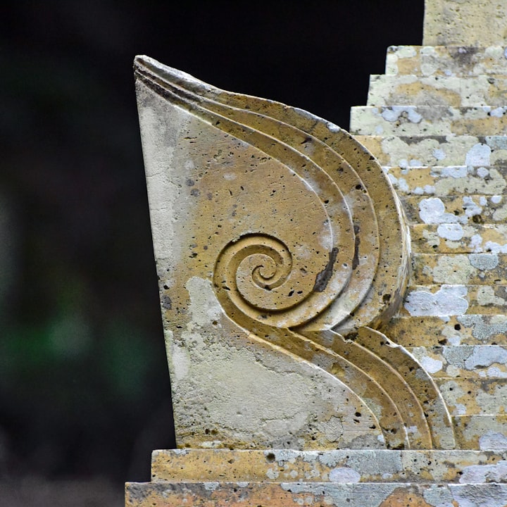 a stone sculpture with a spiral design on it