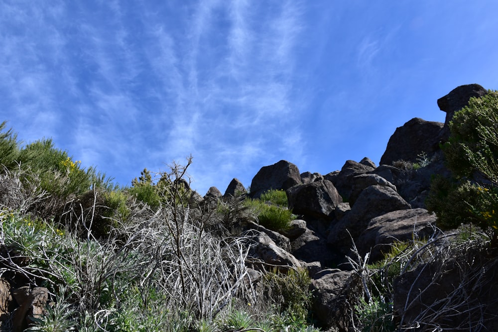 a blue sky with some clouds and some rocks