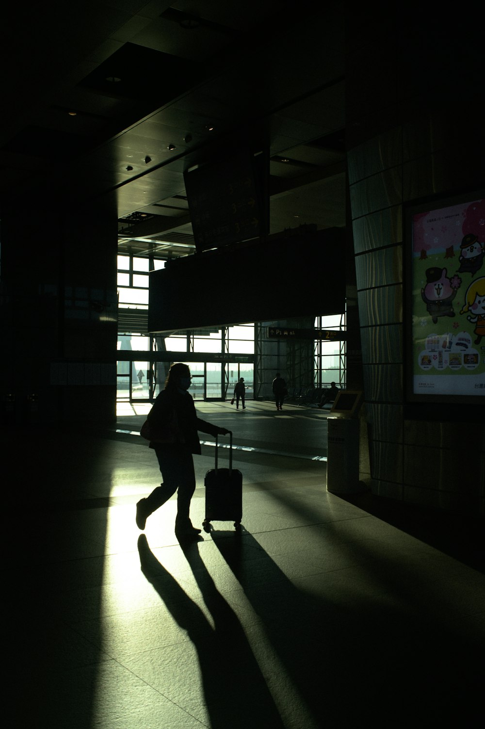 a person with a suitcase in a dark room