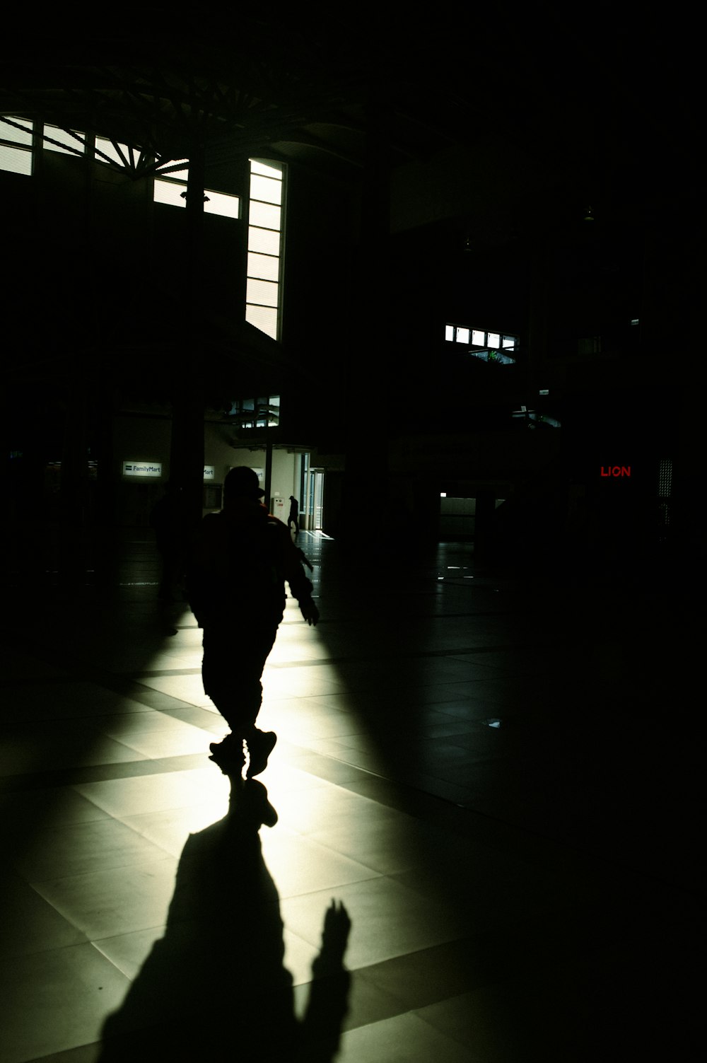 a shadow of a person walking in the dark