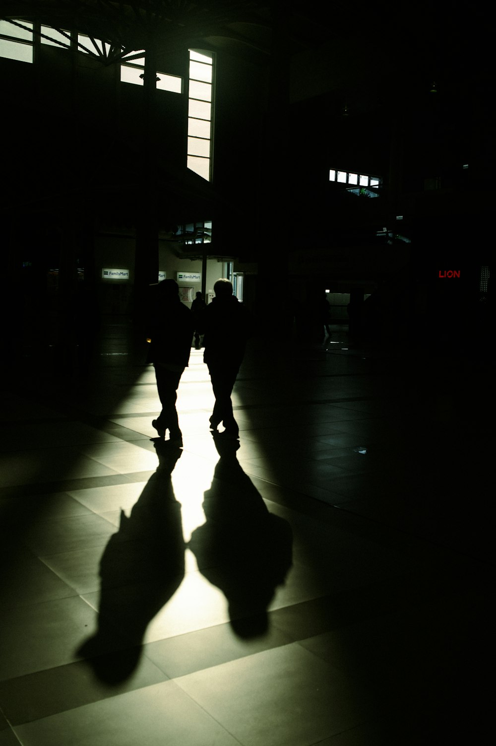 a couple of people that are standing in the dark