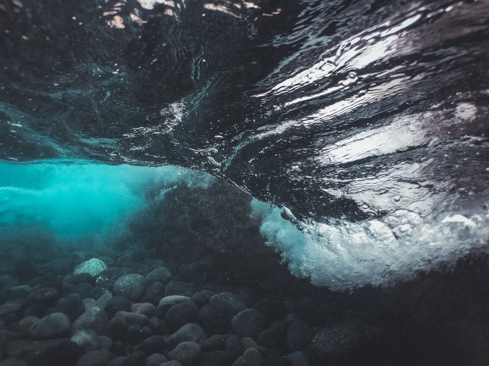 an underwater view of rocks and water