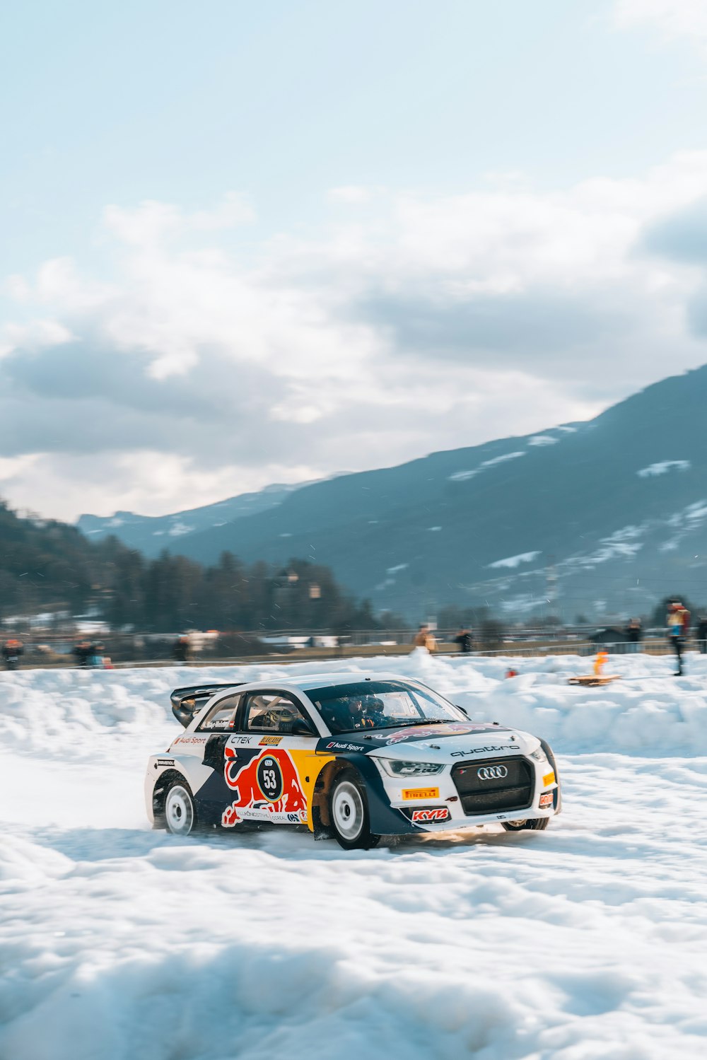 a rally car is driving through the snow