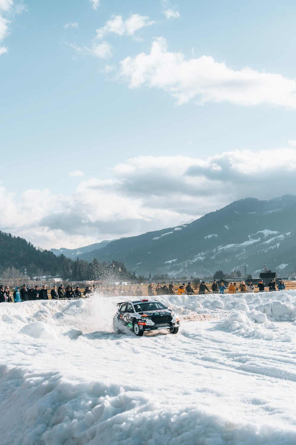 a car driving through a snow covered field