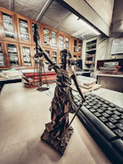 a statue of a lady justice holding a sword next to a keyboard