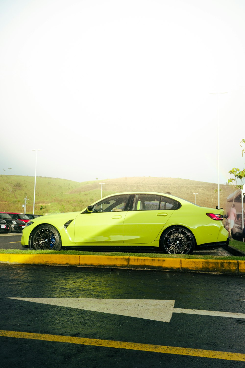 a yellow car is parked on the side of the road