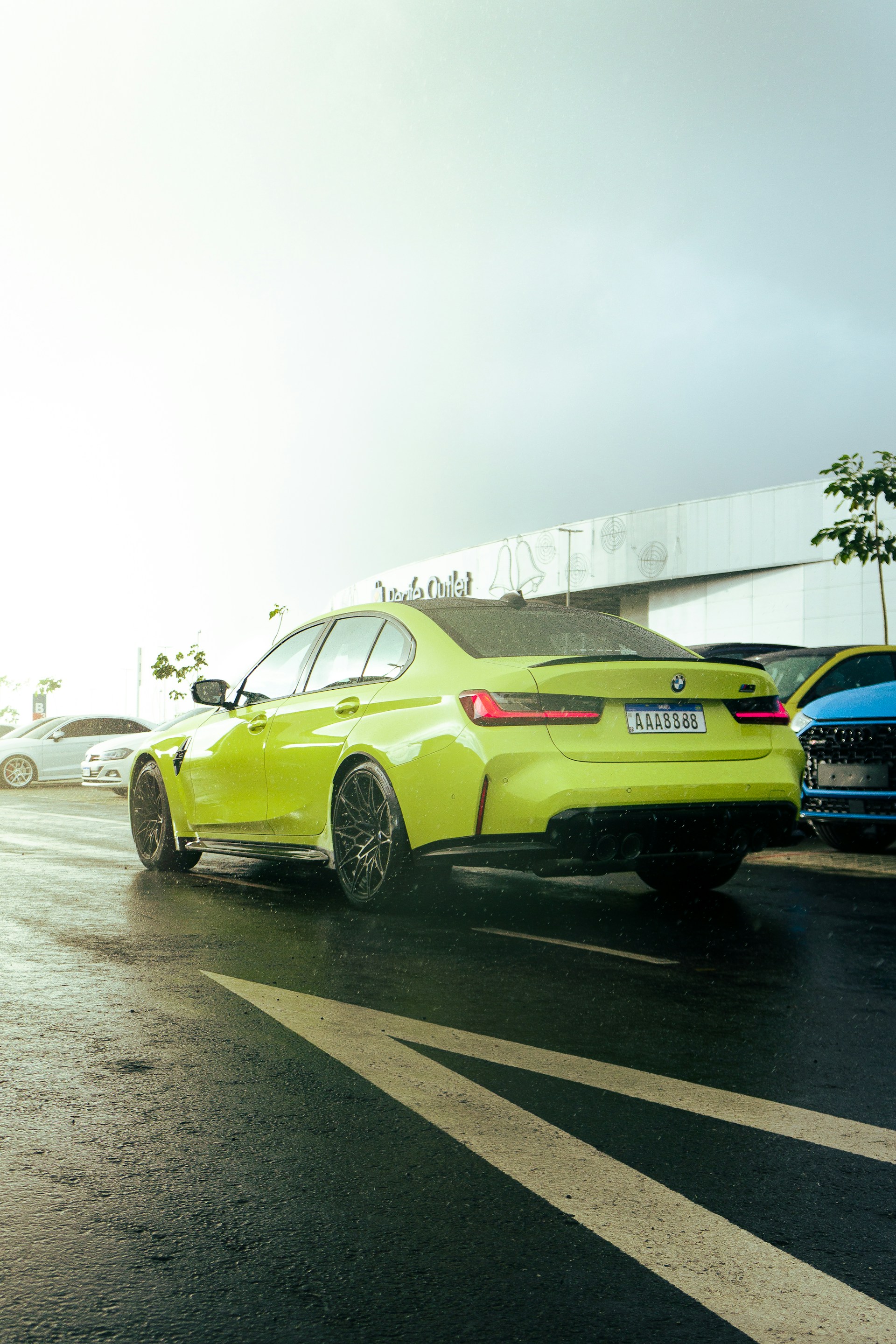 a yellow car is parked on the side of the road