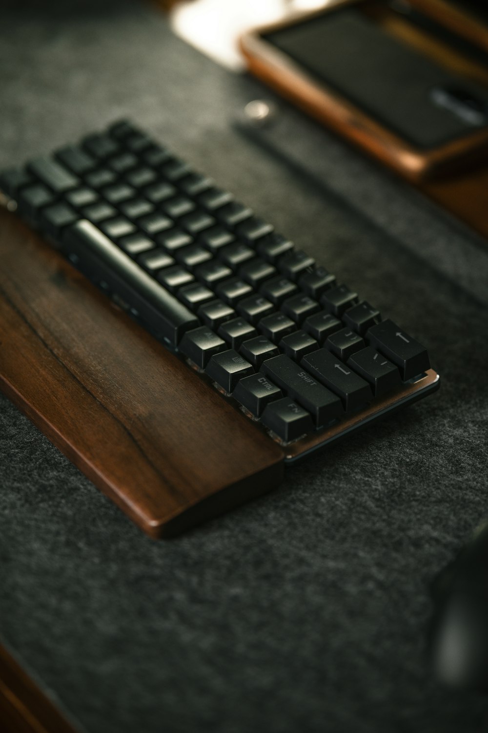 a computer keyboard sitting on top of a wooden desk
