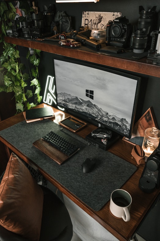 a desk with a monitor, keyboard and mouse