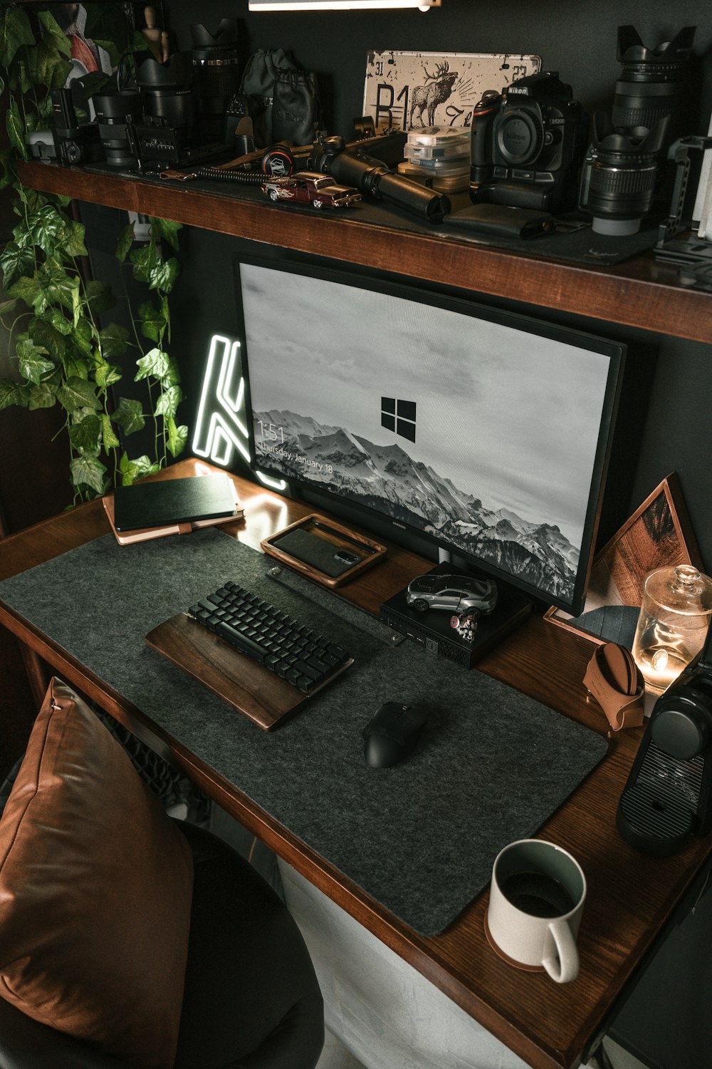 a desk with a monitor, keyboard and mouse
