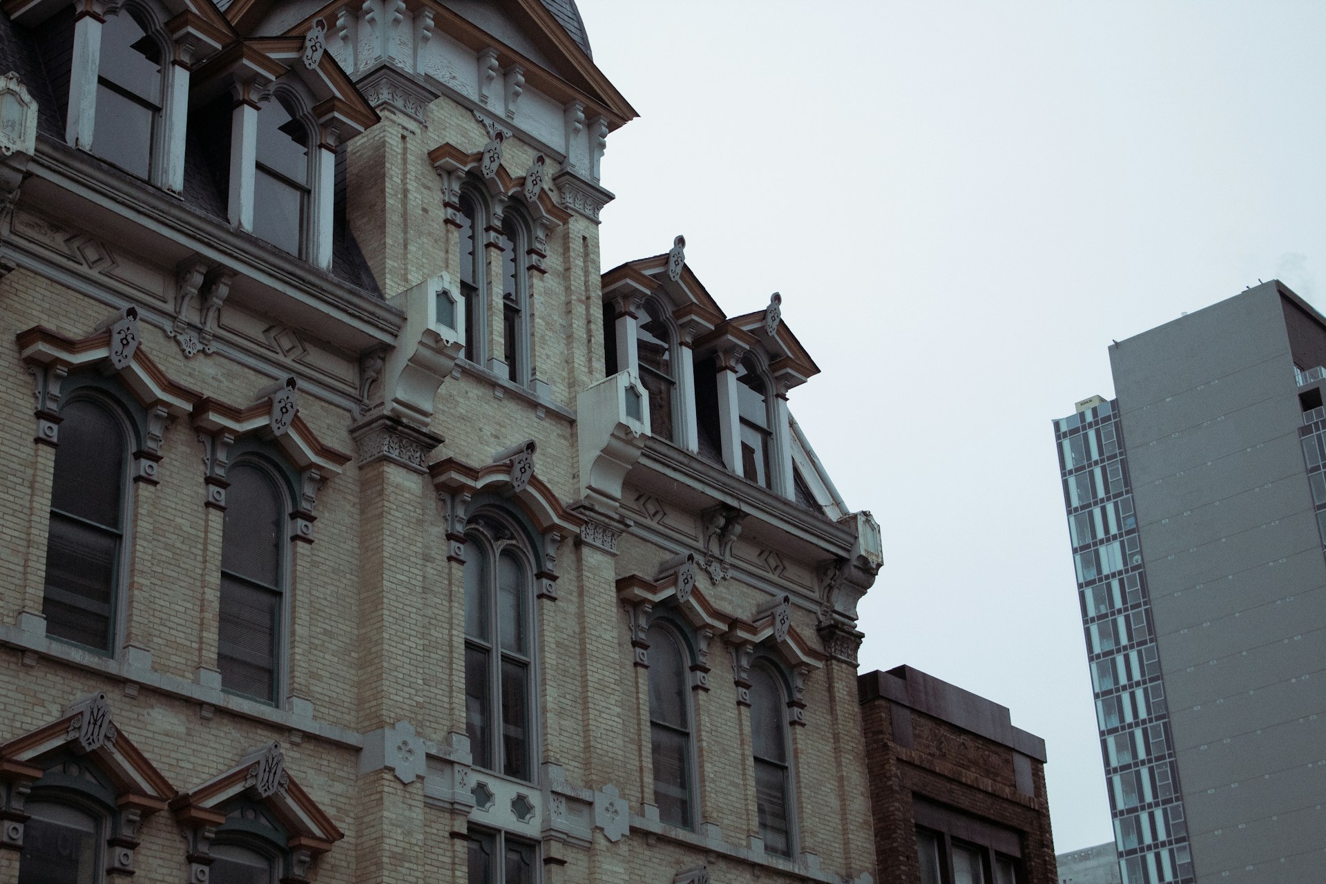 a tall building with many windows next to a tall building