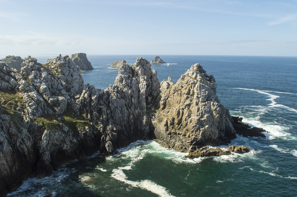 a large body of water next to a rocky shore