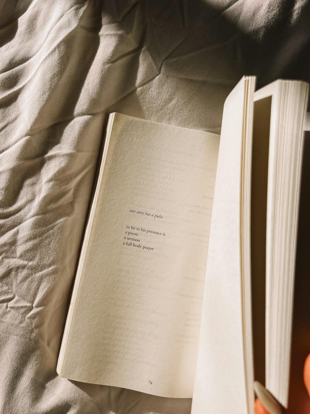 a person is reading a book on a bed