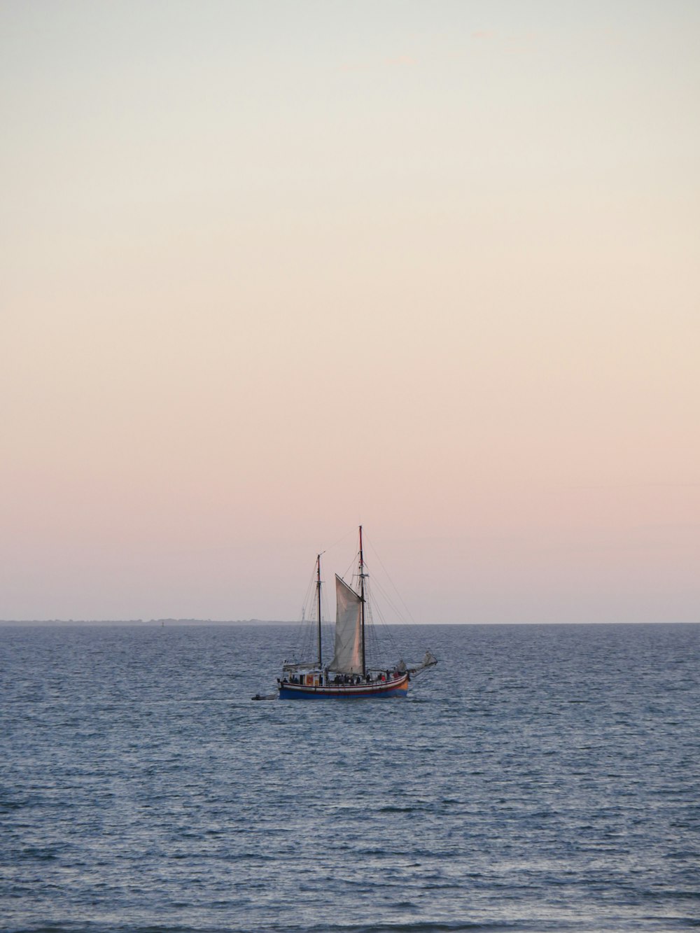 a sailboat sailing across a large body of water