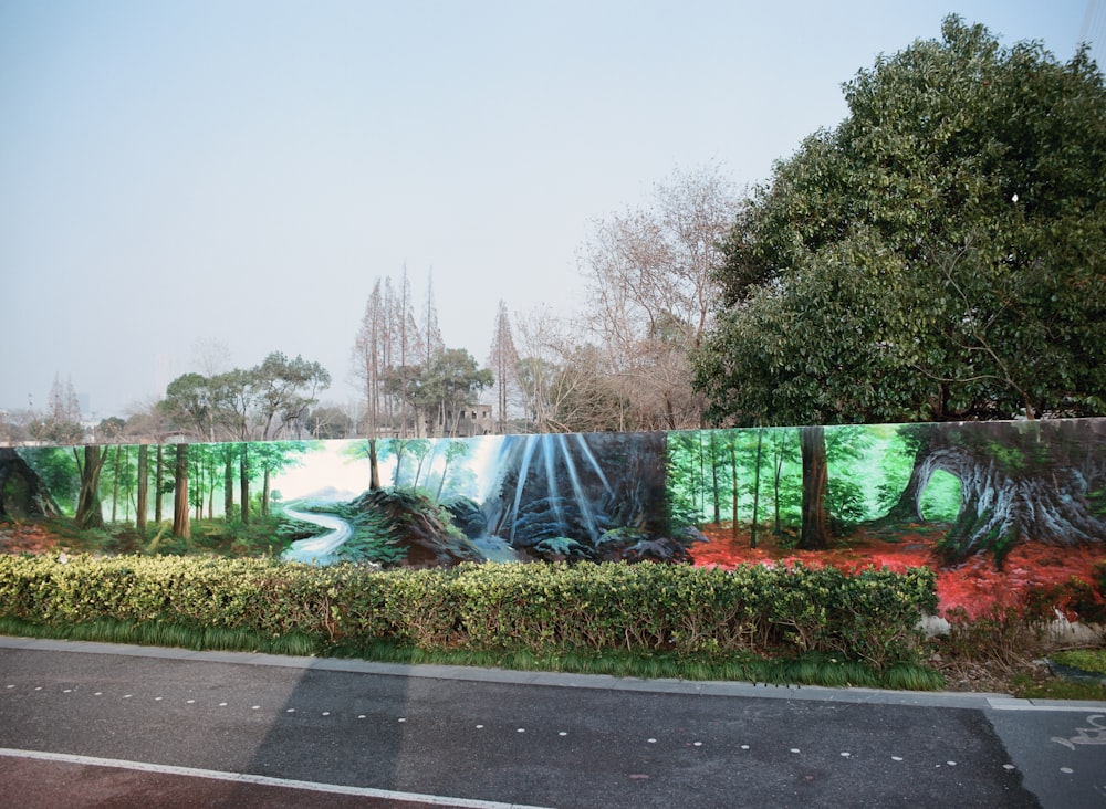 a mural of a forest with a river running through it