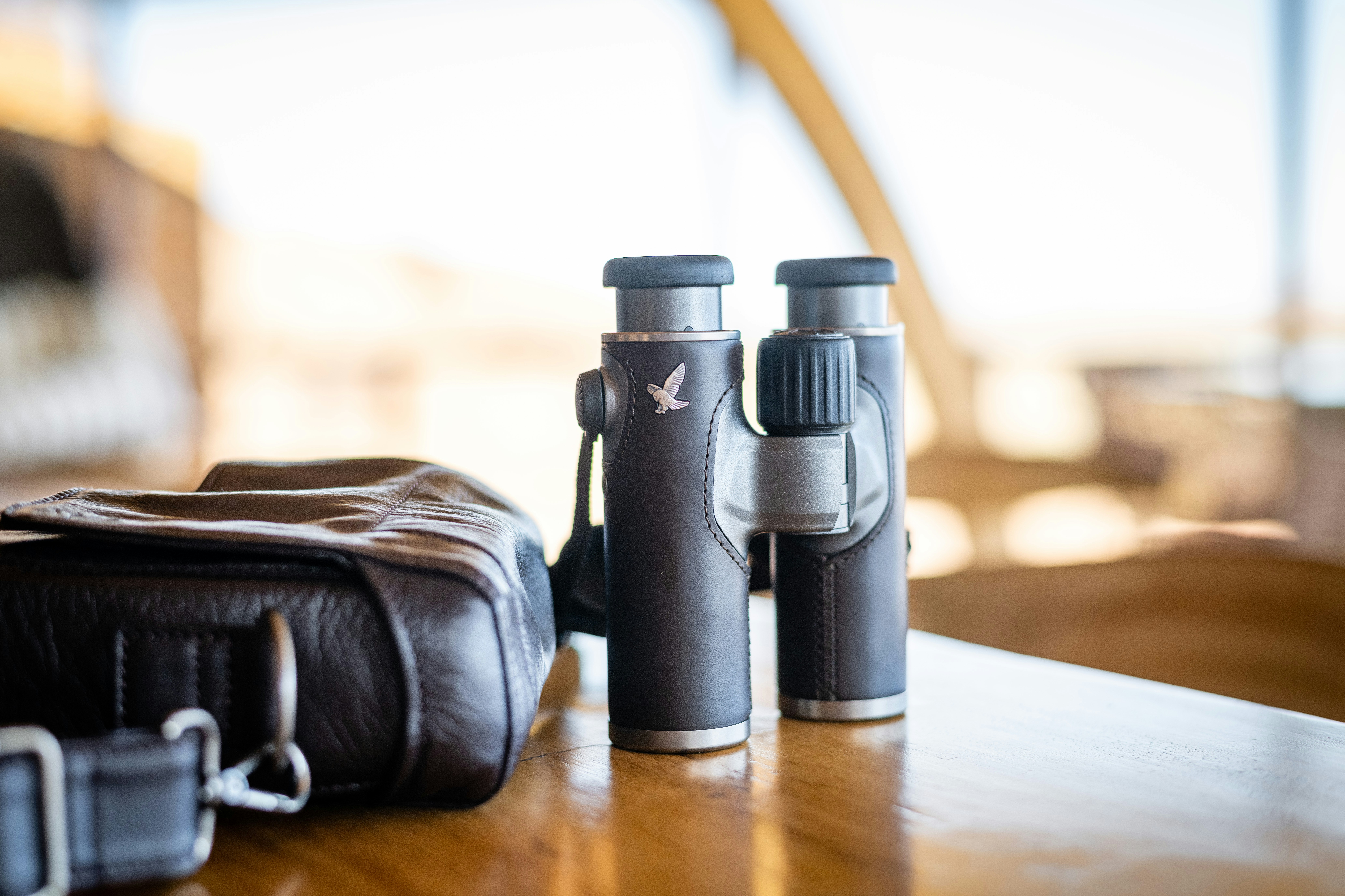 a couple of binoculars sitting on top of a wooden table