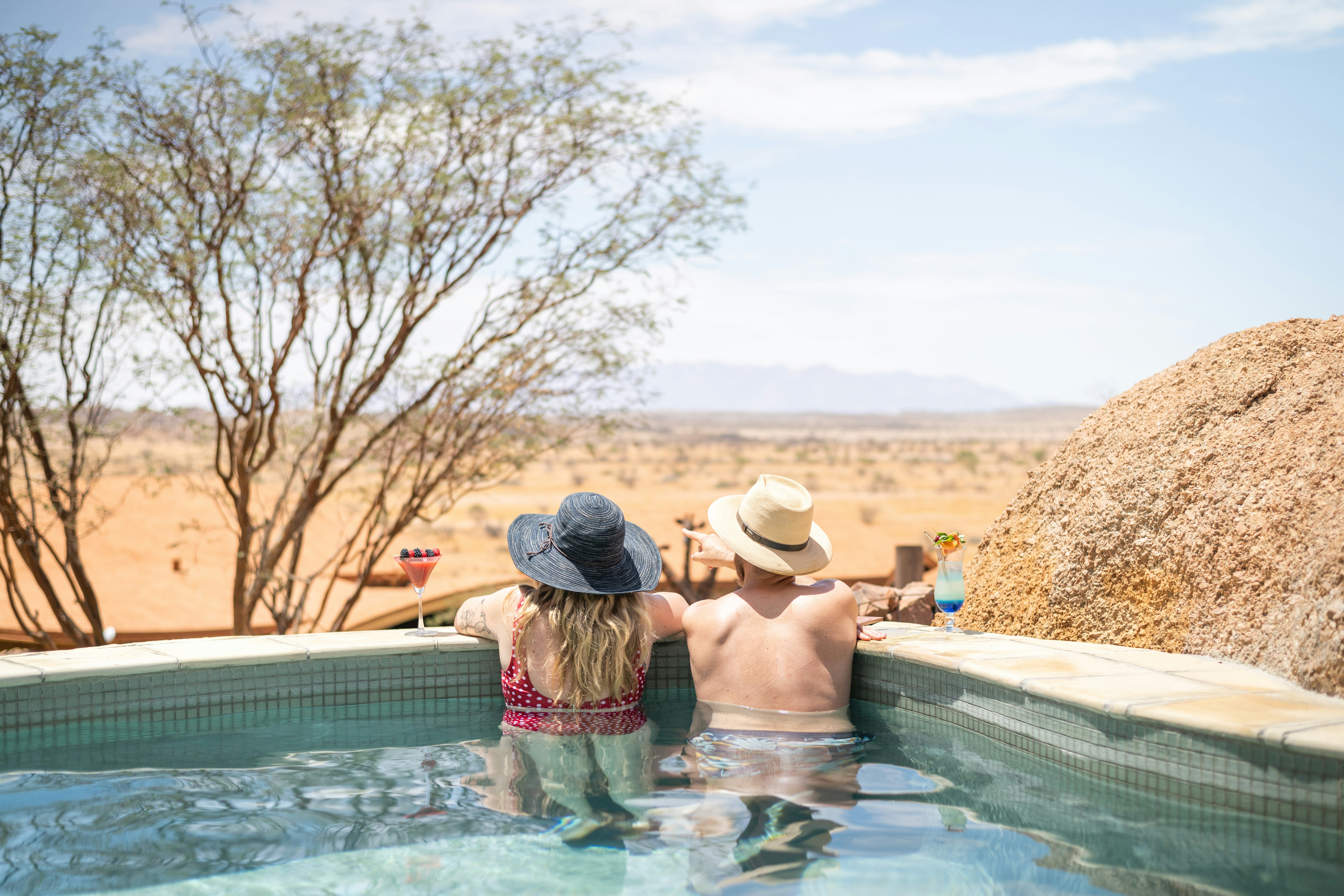 a couple of people that are in a pool