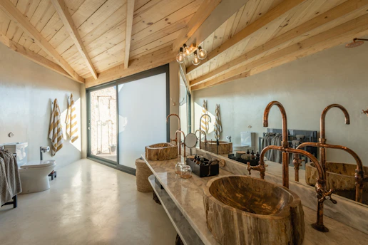 a bathroom with two sinks and a tub