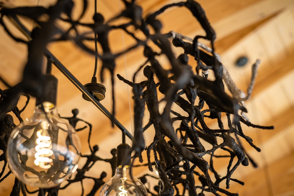 a chandelier made out of branches and light bulbs