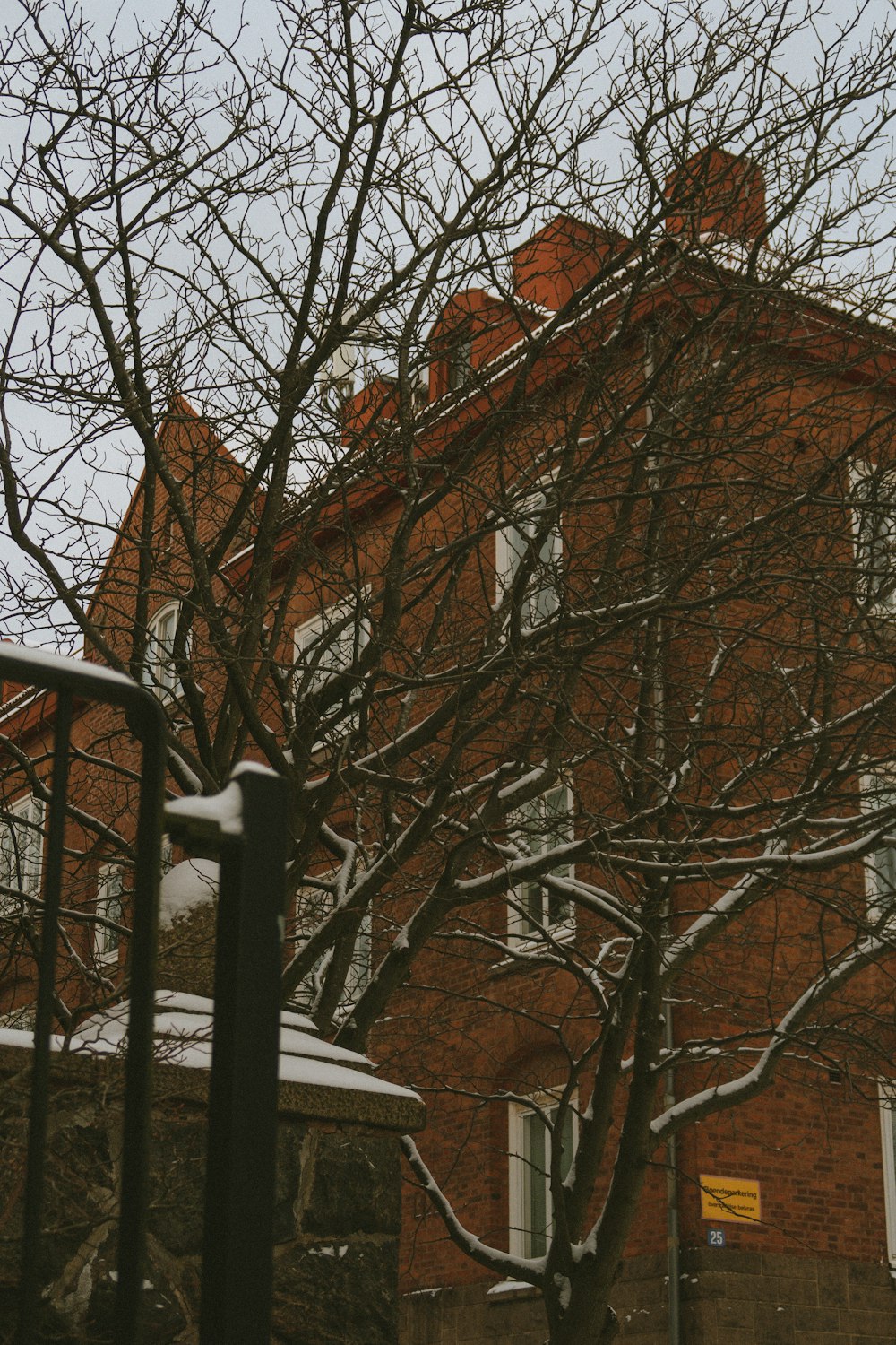 a red brick building with snow on the ground
