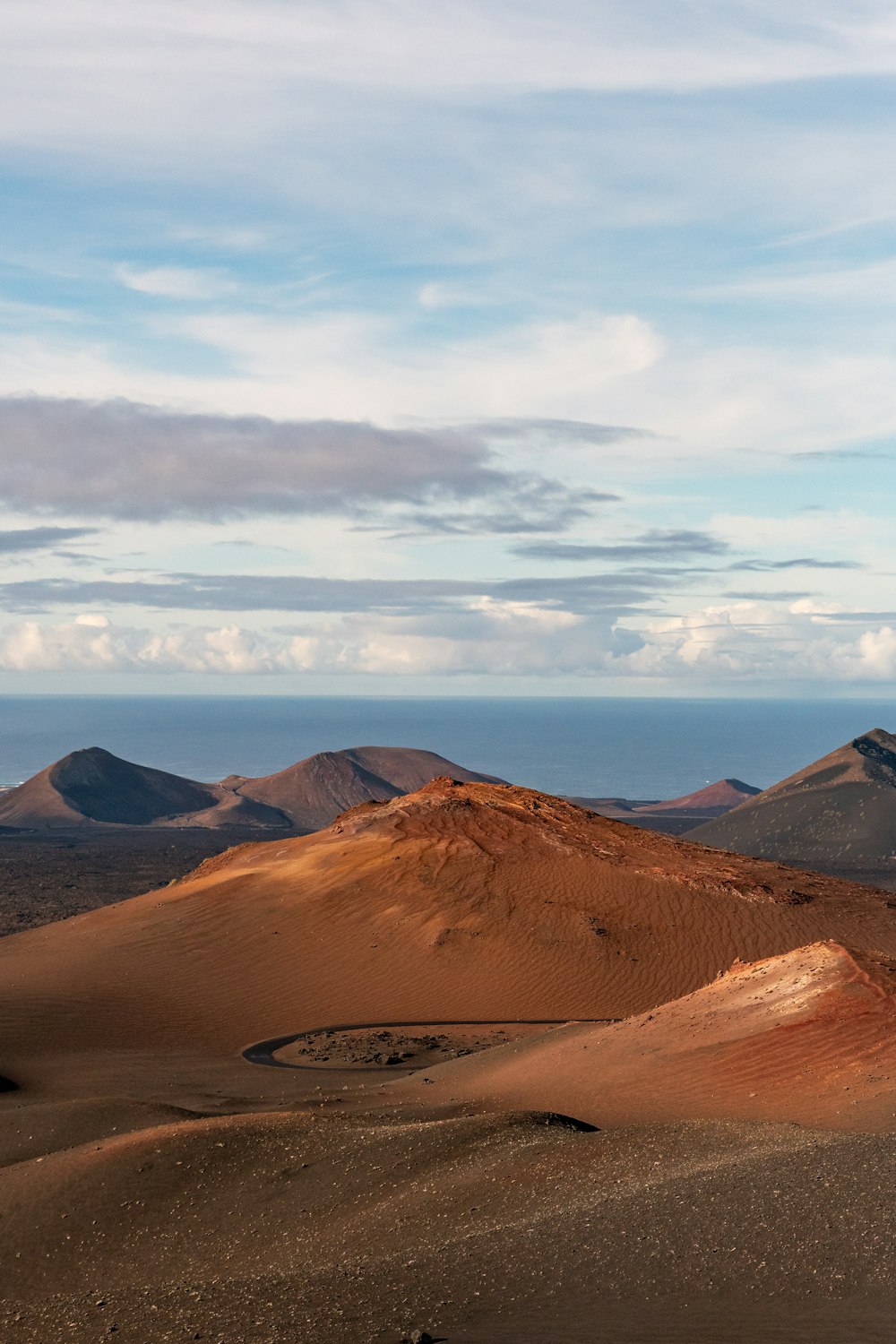 a group of mountains in the distance with a body of water in the distance