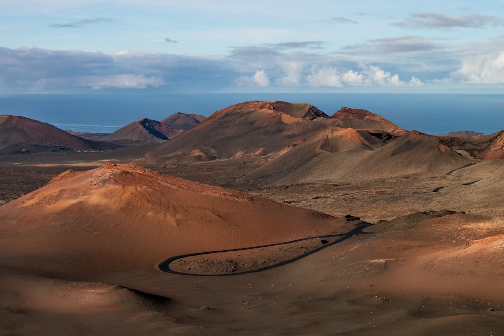 a dirt road winding through a desert landscape