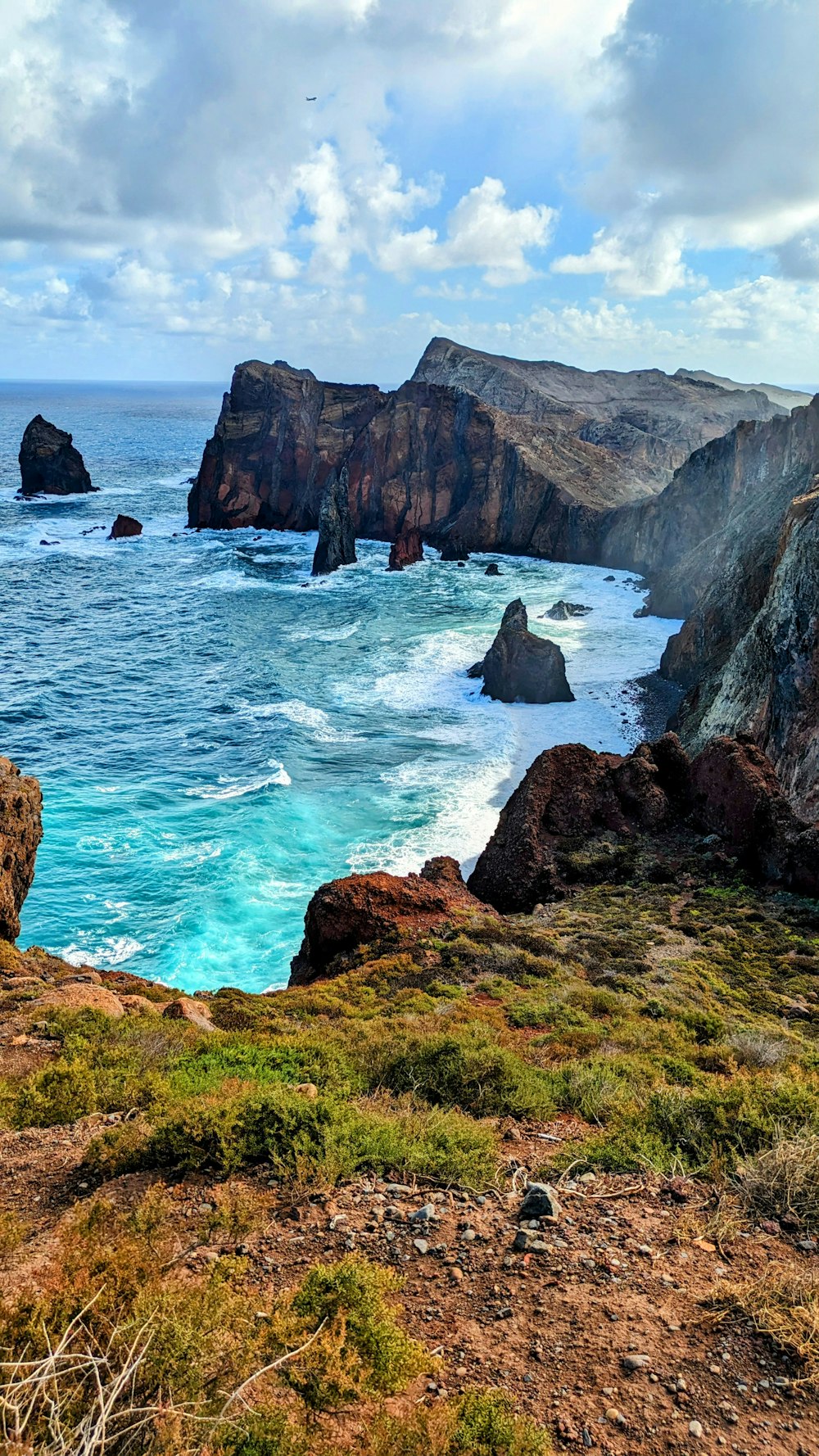 a view of the ocean from the top of a hill