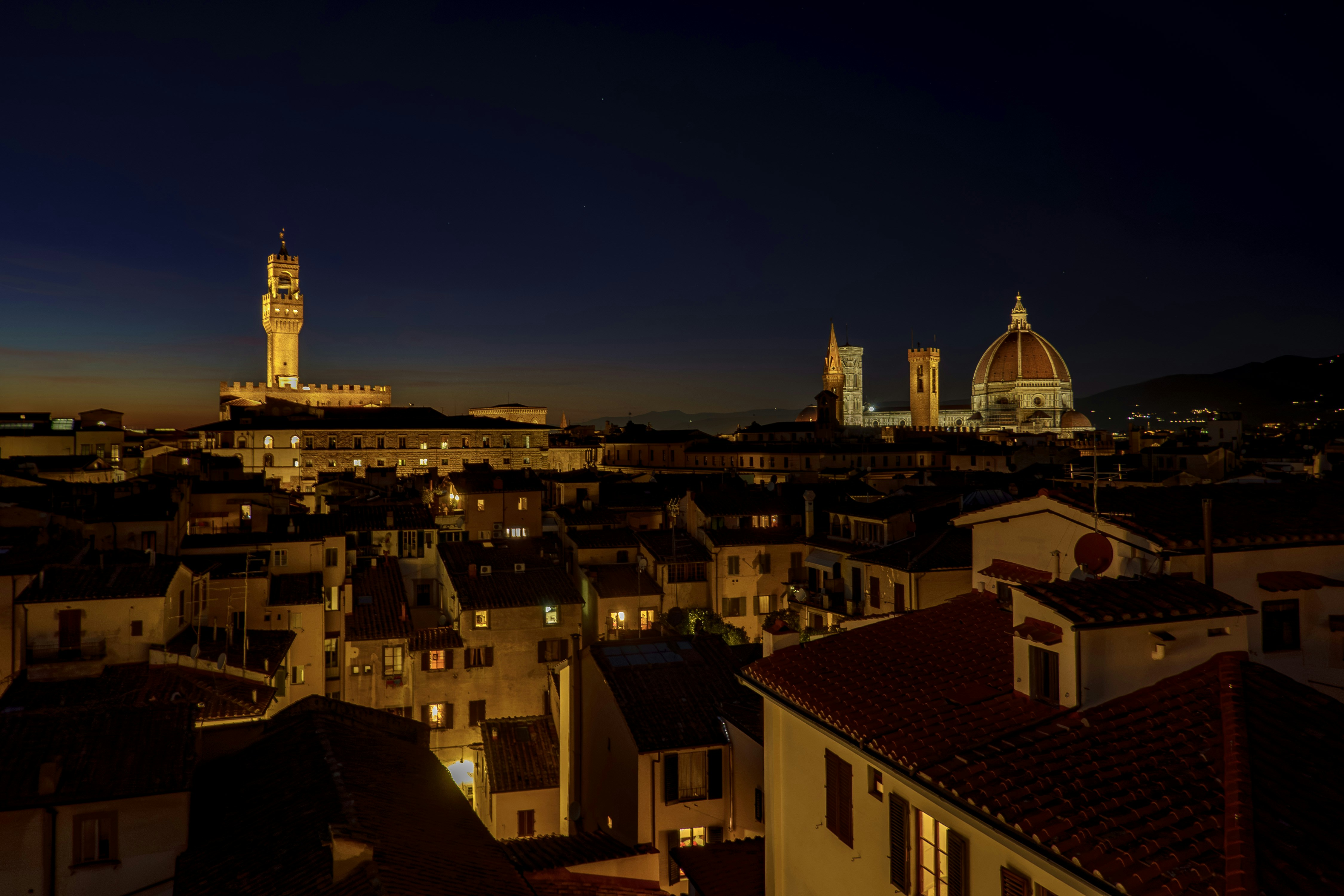 A view of a city at night from a rooftop