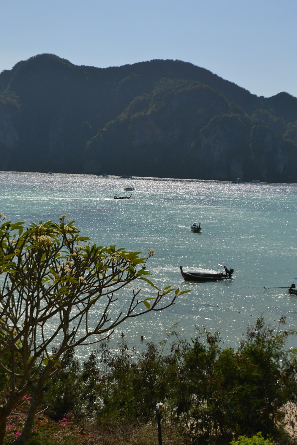 a group of boats floating on top of a large body of water